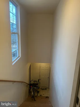 a view of a room with wooden floor and windows