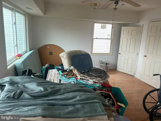 a view of a room that has a bed and a window