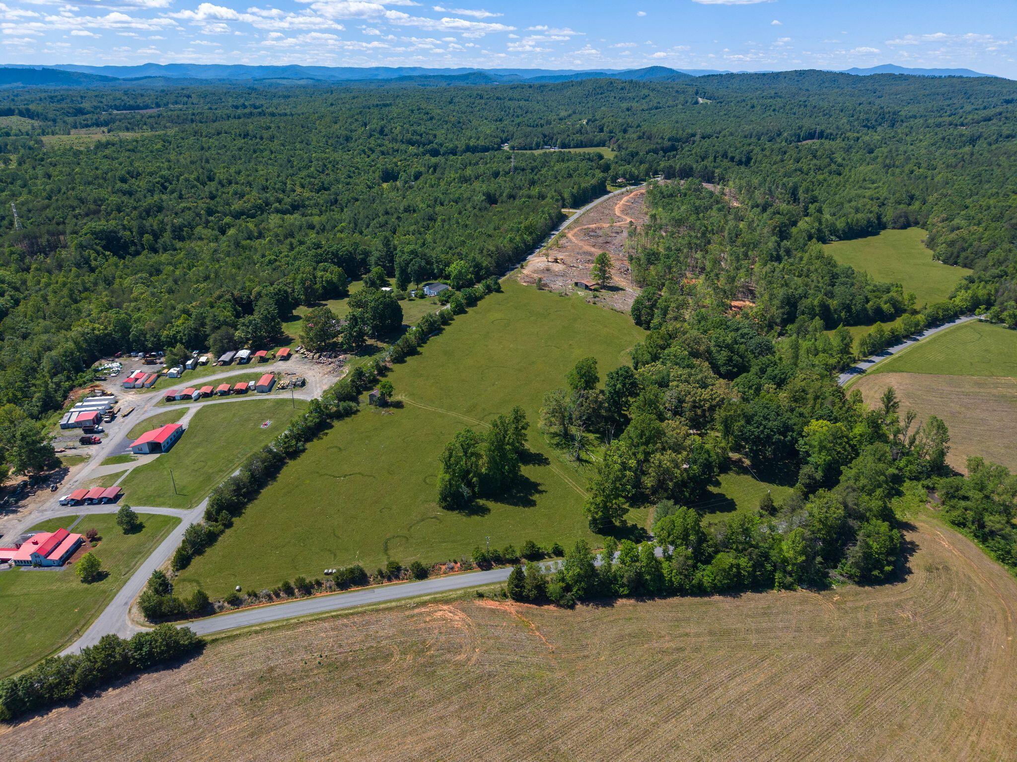 1115 Robin Ridge Road Henry, VA 24102 - Photo 46 of 54 an aerial view of green landscape with trees houses and mountain view