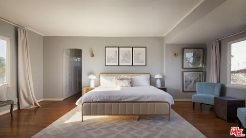 a bedroom with a bed wooden floor and a potted plant