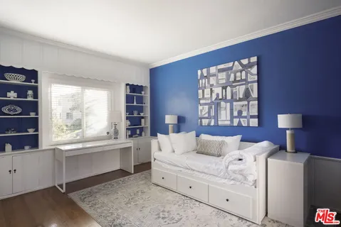 a bed room with a bed and a large window