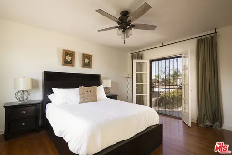 a bedroom with a large bed and a large window