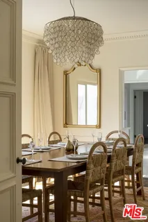 a dining table with chairs and window