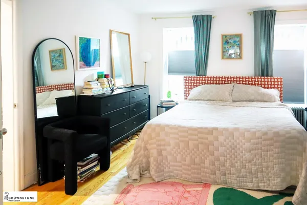 a bedroom with bed and a mirror