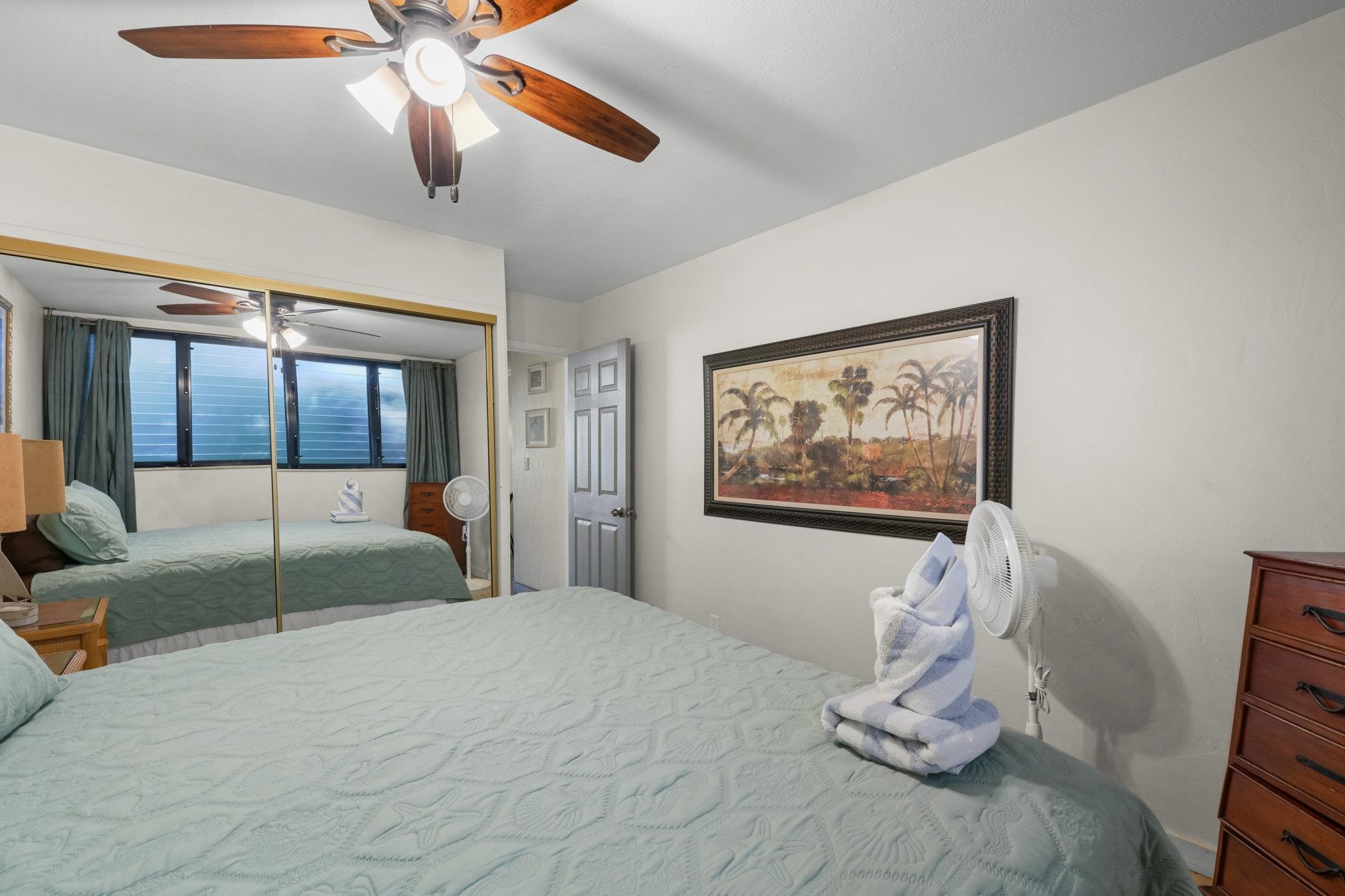 3975 Lower Honoapiilani Road, Unit 120 Lahaina, HI 96761 - Photo 17 of 22 a bedroom with a bed and a painting on the wall