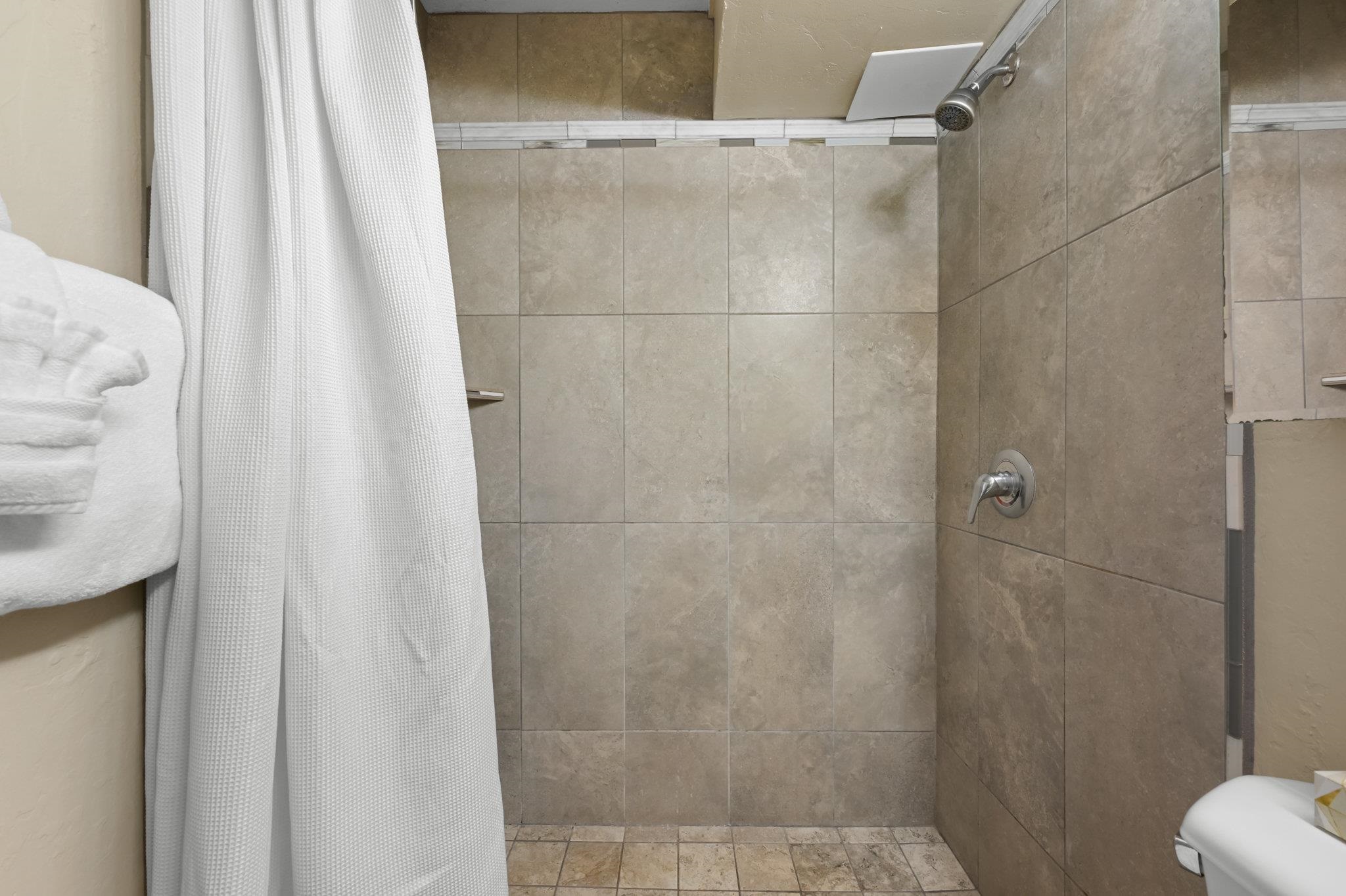 3975 Lower Honoapiilani Road, Unit 120 Lahaina, HI 96761 - Photo 19 of 22 a bathroom with a shower curtain