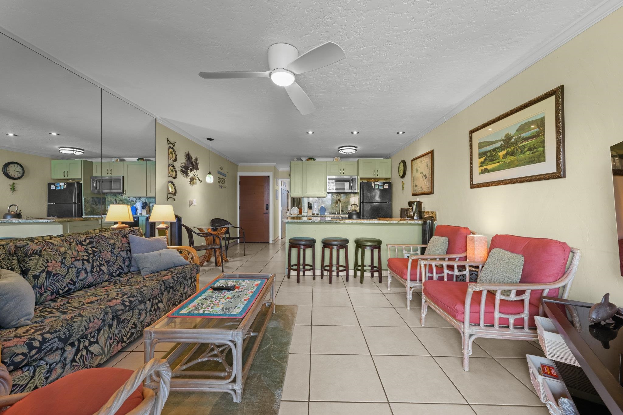 3975 Lower Honoapiilani Road, Unit 120 Lahaina, HI 96761 - Photo 5 of 22 a living room with furniture and a dining table with kitchen view
