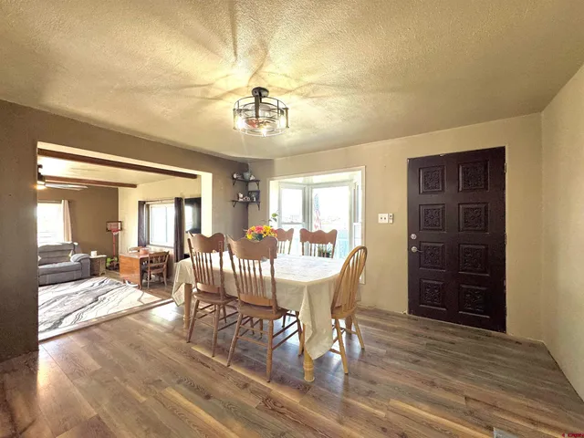 a kitchen with granite countertop wooden cabinets stainless steel appliances a sink and a window