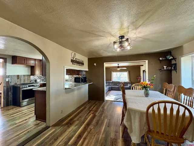 a kitchen with stainless steel appliances granite countertop wooden cabinets a refrigerator and sink