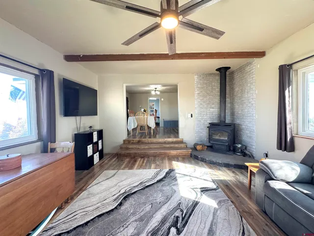 a kitchen with stainless steel appliances granite countertop a refrigerator a sink and wooden cabinets