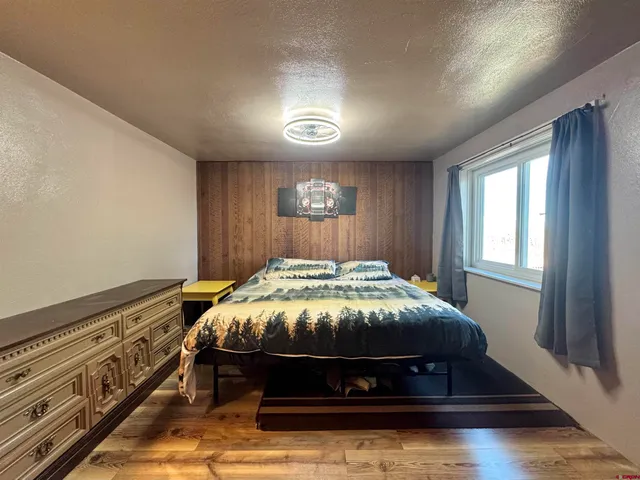 a view of a yard with wooden fence