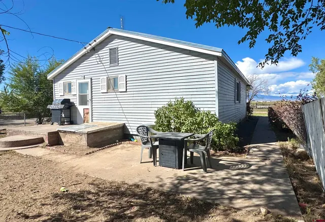 a view of a house with a snow in the background