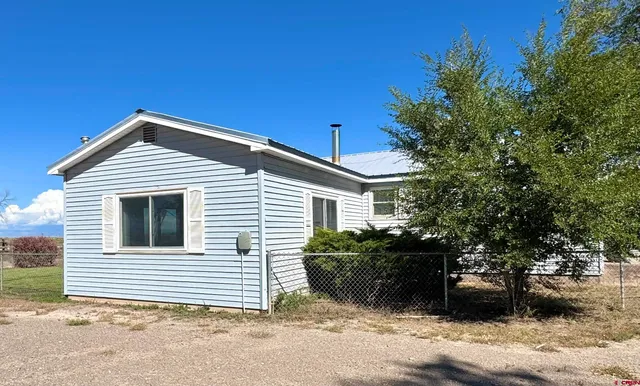 a house with trees in the background