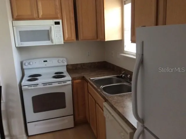 a kitchen with a stove and a microwave