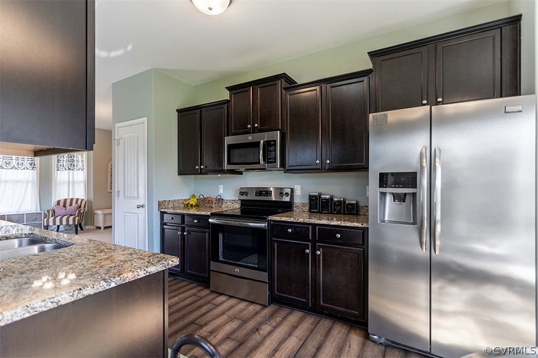 5531 Garden Grove Road Chesterfield, VA 23832 - Photo 12 of 32 a kitchen with kitchen island granite countertop stainless steel appliances and wooden cabinets