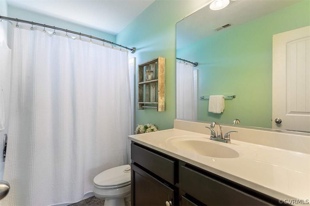 5531 Garden Grove Road Chesterfield, VA 23832 - Photo 25 of 32 a bathroom with a double vanity sink toilet and a mirror