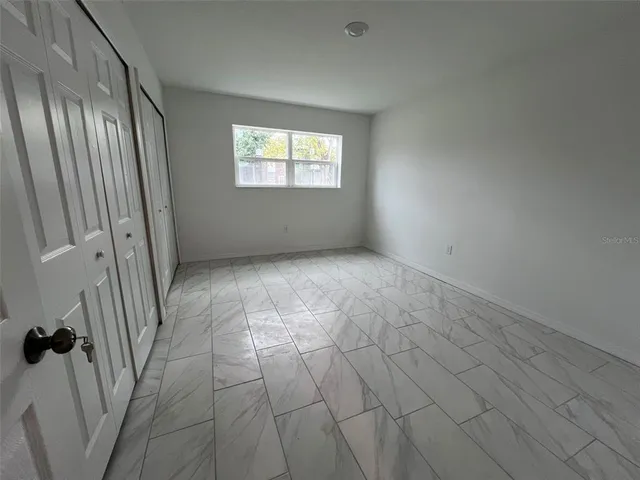 a view of an empty room with a window