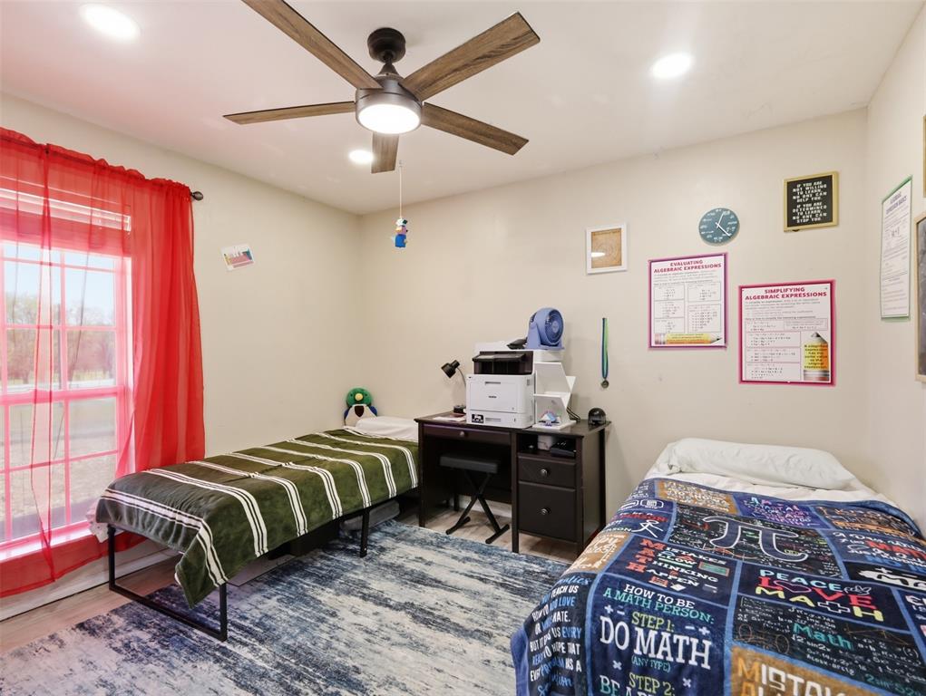 3823 State Highway Bonham, TX 75418 - Photo 27 of 37 a bedroom with a bed and a chandelier