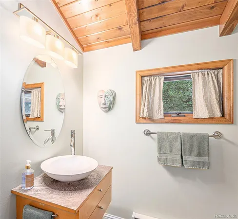 a room with a mirror a sink and a window