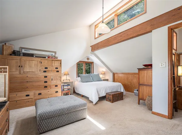 a bedroom with bed and a window