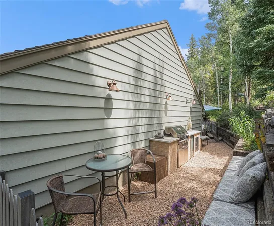 a backyard of a house with table and chairs