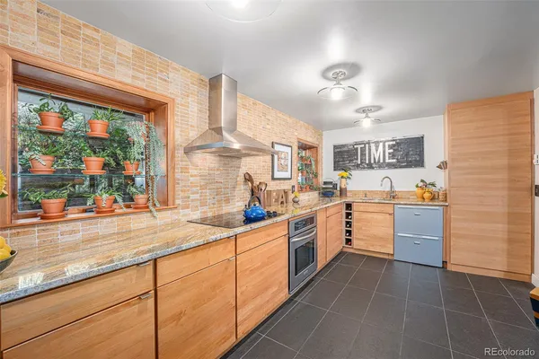 a kitchen with a sink window and cabinets