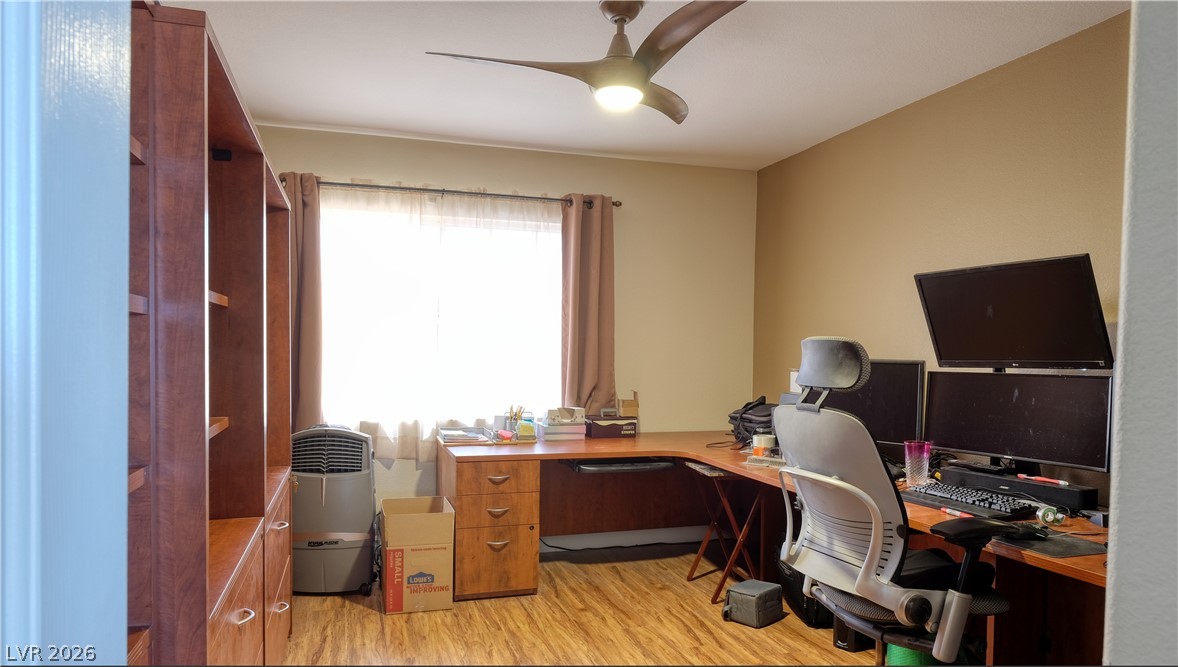 3704 North Campbell Road Las Vegas, NV 89129 - Photo 29 of 46 A well-lit home office features hardwood-style flooring and a contemporary ceiling fan.