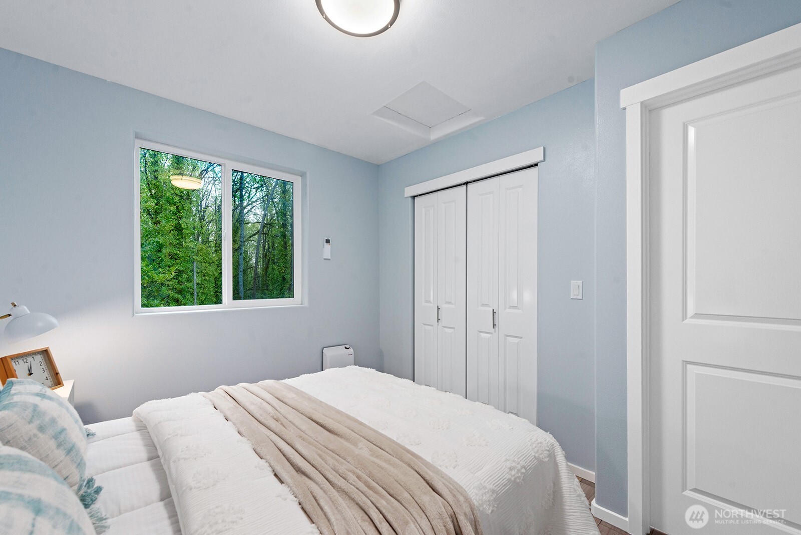 3265 31st Avenue Southwest Seattle, WA 98126 - Photo 12 of 18 a bedroom with a bed and a window
