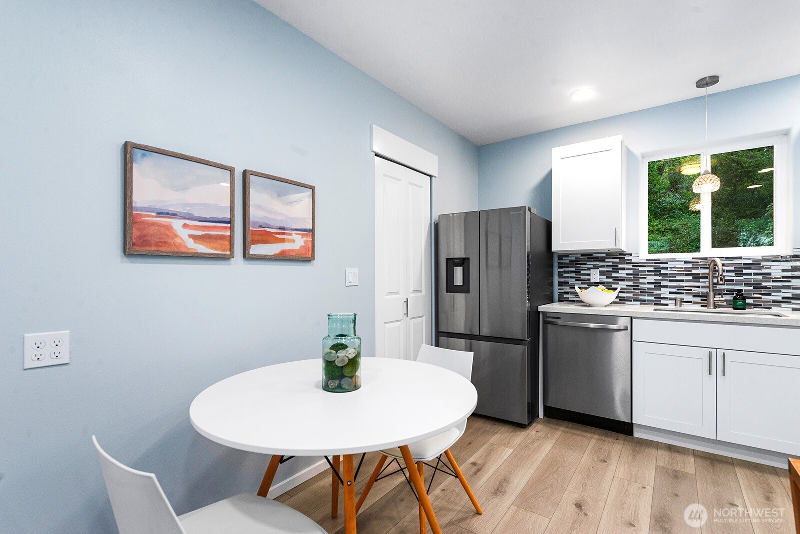 3265 31st Avenue Southwest Seattle, WA 98126 - Photo 5 of 18 a kitchen with stainless steel appliances a dining table chairs and refrigerator