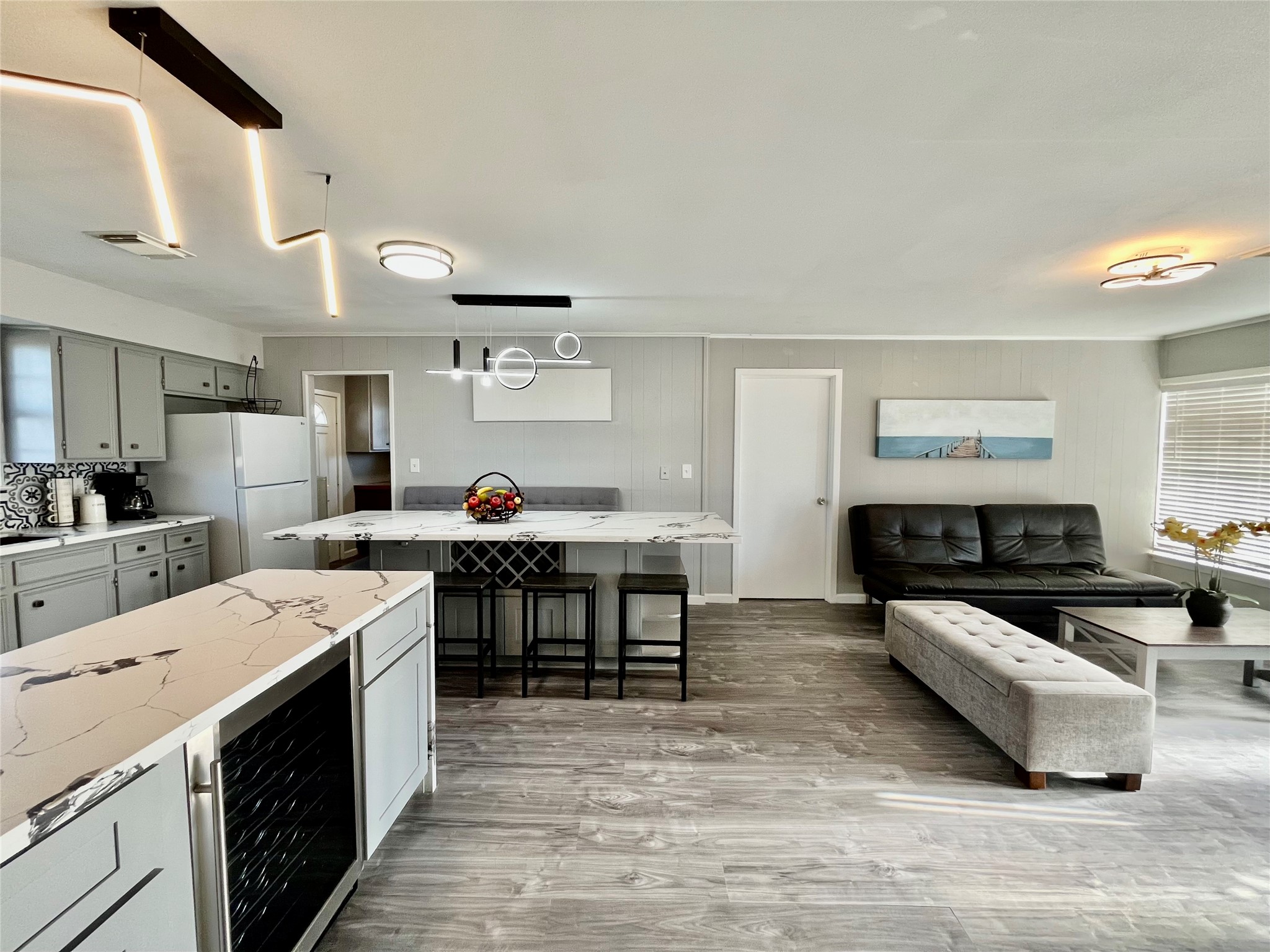 610 Seashell Drive Surfside Beach, TX 77541 - Photo 12 of 42 a large white kitchen with stainless steel appliances kitchen island a stove and a refrigerator