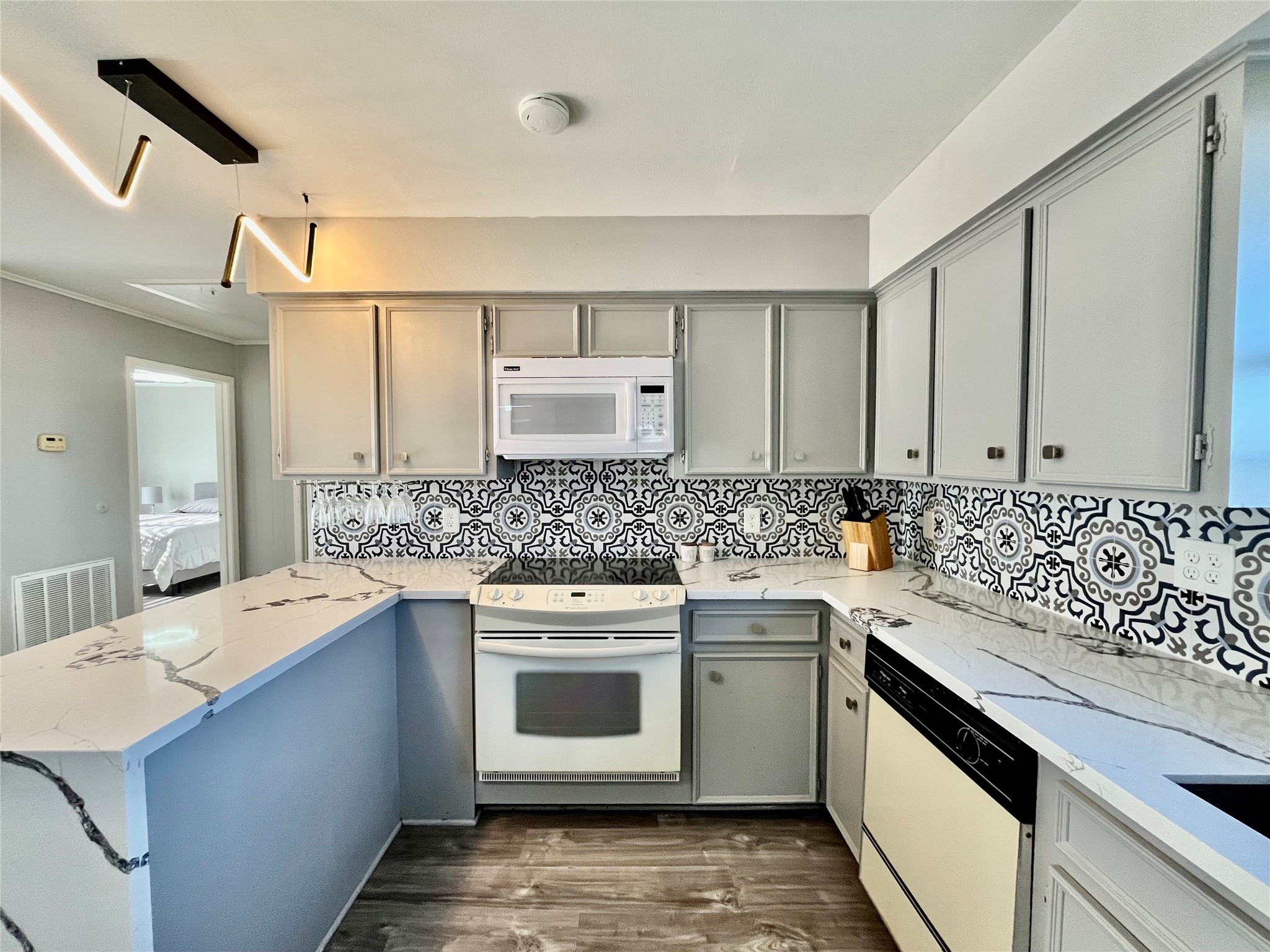 610 Seashell Drive Surfside Beach, TX 77541 - Photo 18 of 42 a kitchen with a sink stove and cabinets
