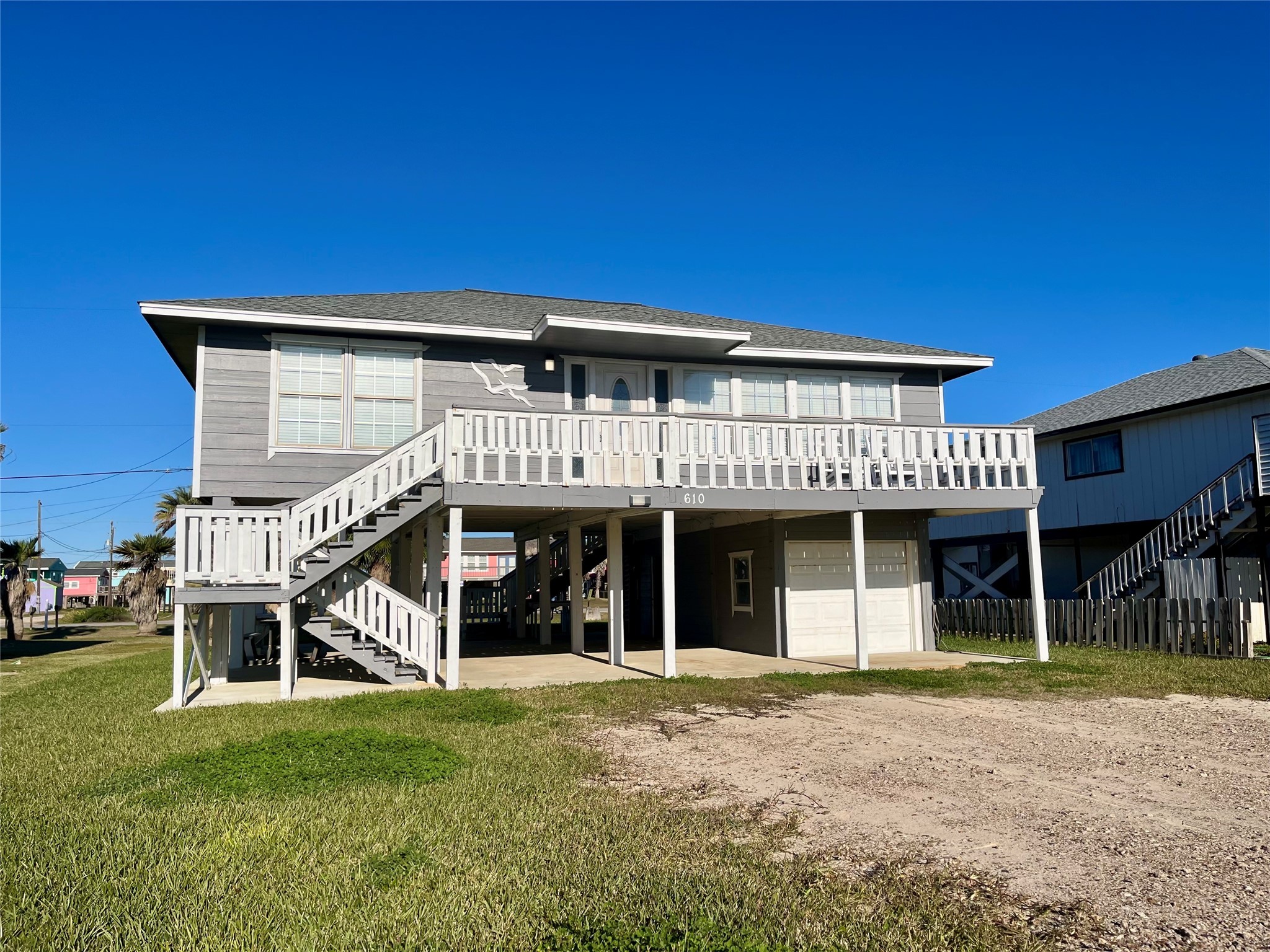 610 Seashell Drive Surfside Beach, TX 77541 - Photo 3 of 42 a front view of a house with a garden