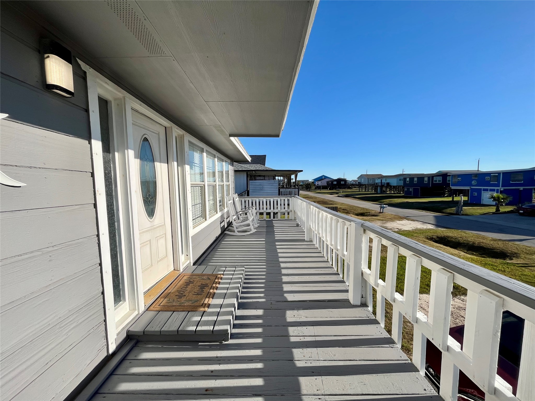 610 Seashell Drive Surfside Beach, TX 77541 - Photo 5 of 42 a view of a balcony with wooden floor and staircase