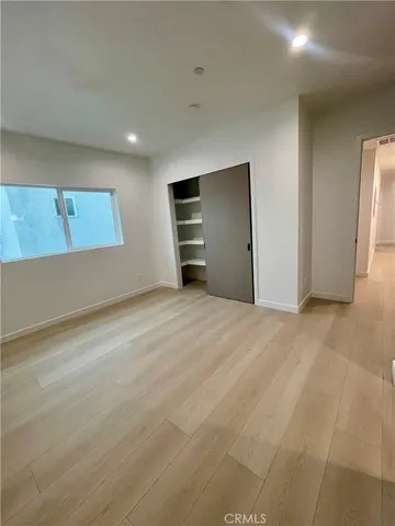 a white toilet sitting next to a shower