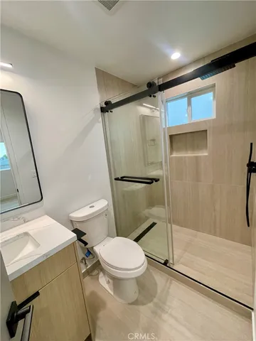 a large building with a small yard and large trees