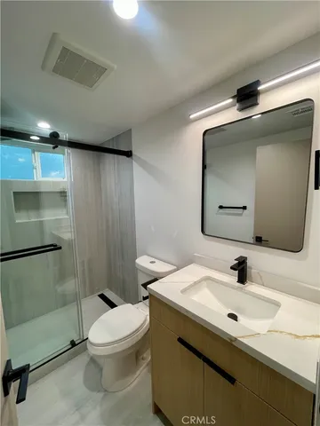 a bathroom with a sink toilet and shower