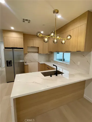 a kitchen with refrigerator and microwave