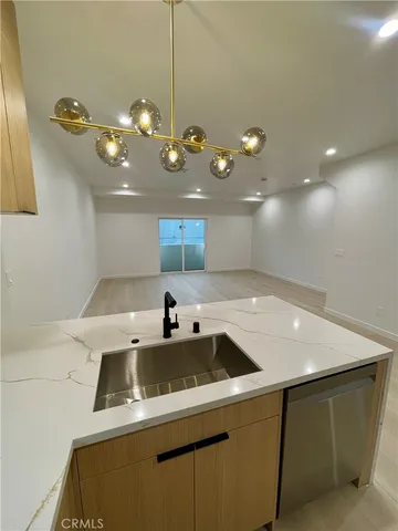 a kitchen with a sink and chandelier