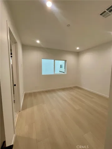 an empty room with a empty space and windows