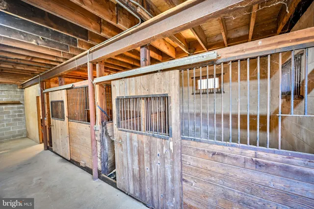 a living room with wooden floors and a large window