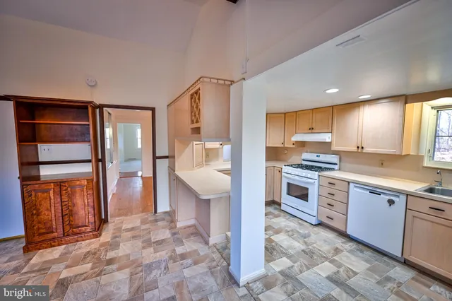 a view of wooden floor and windows in a room