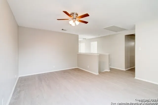 an empty room with closet and windows