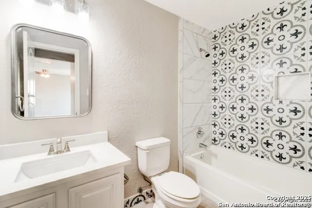 a white toilet sitting next to a bathroom sink