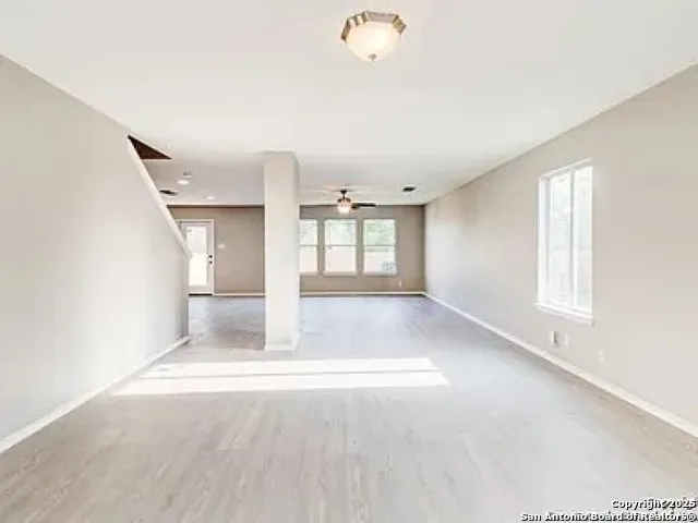 an empty room with windows and entrance