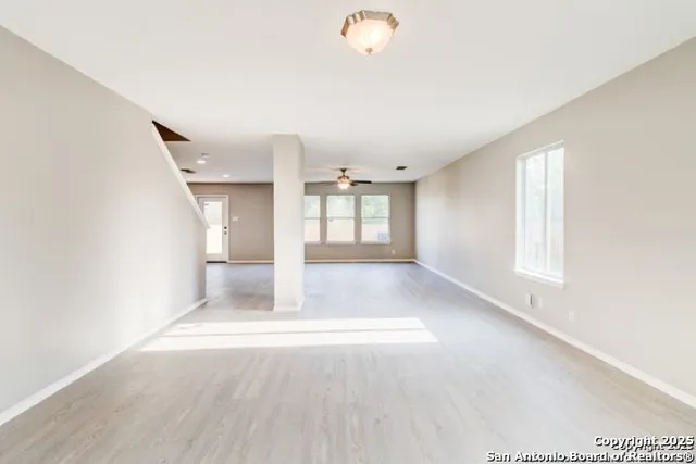 wooden floor in an empty room with a window