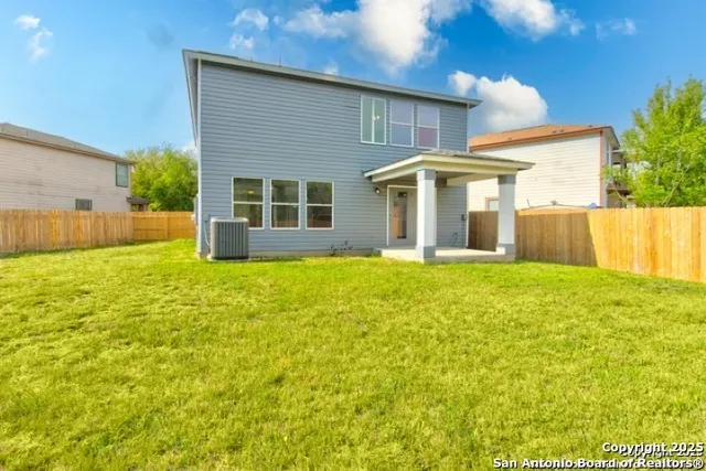 a front view of house with yard and trees around