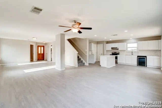 a view of a living room a ceiling fan and window