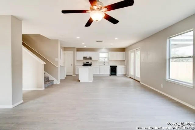 a view of empty room with a ceiling fan and window