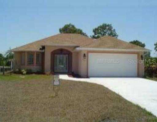 251 Albatross Road Rotonda West, FL 33947 - Photo 1 of 1 a front view of a house with a yard and garage