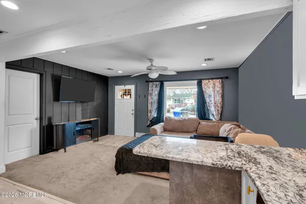 a bedroom with a large bed and a flat screen tv